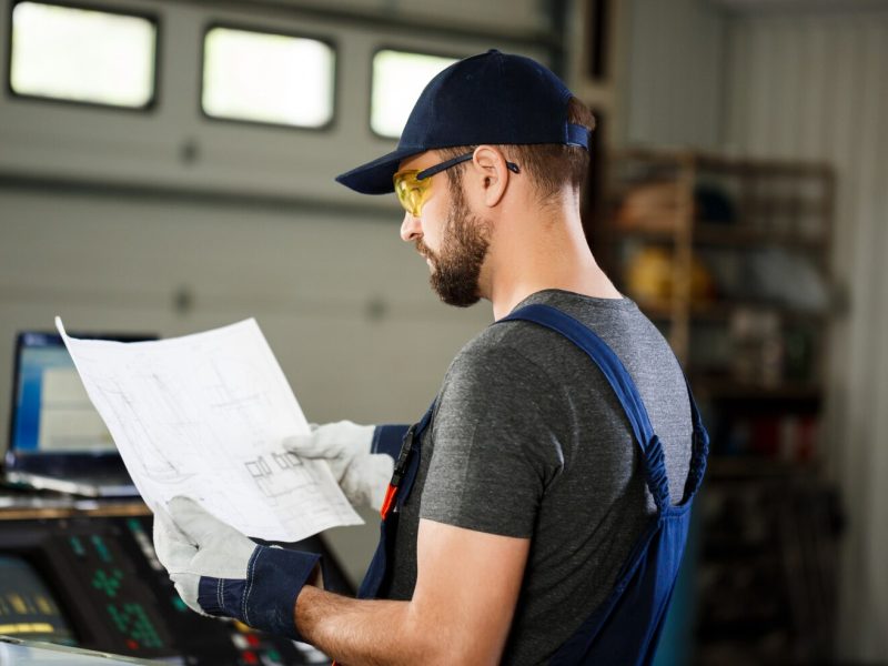 portrait-worker-overalls-steel-factory-background_176420-5568