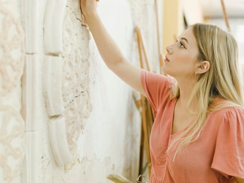 woman-doing-carving-design-wall_23-2147889834